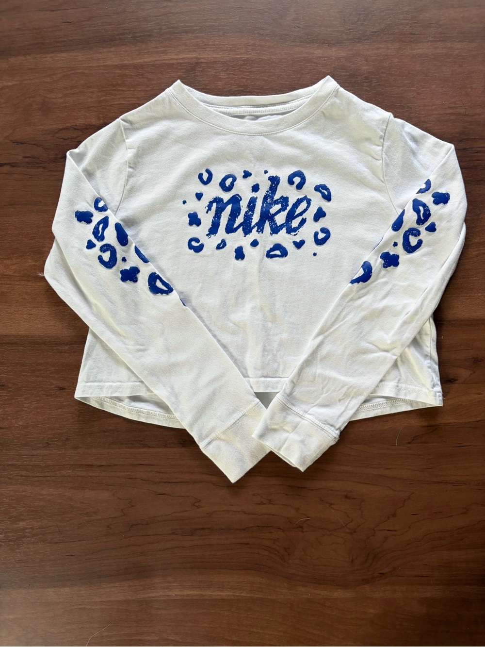 Nike Girls White Long Sleeve Cropped Tee with Blue Leopard Print - Medium